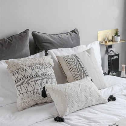 Geometric black and white tufted tassel pillow