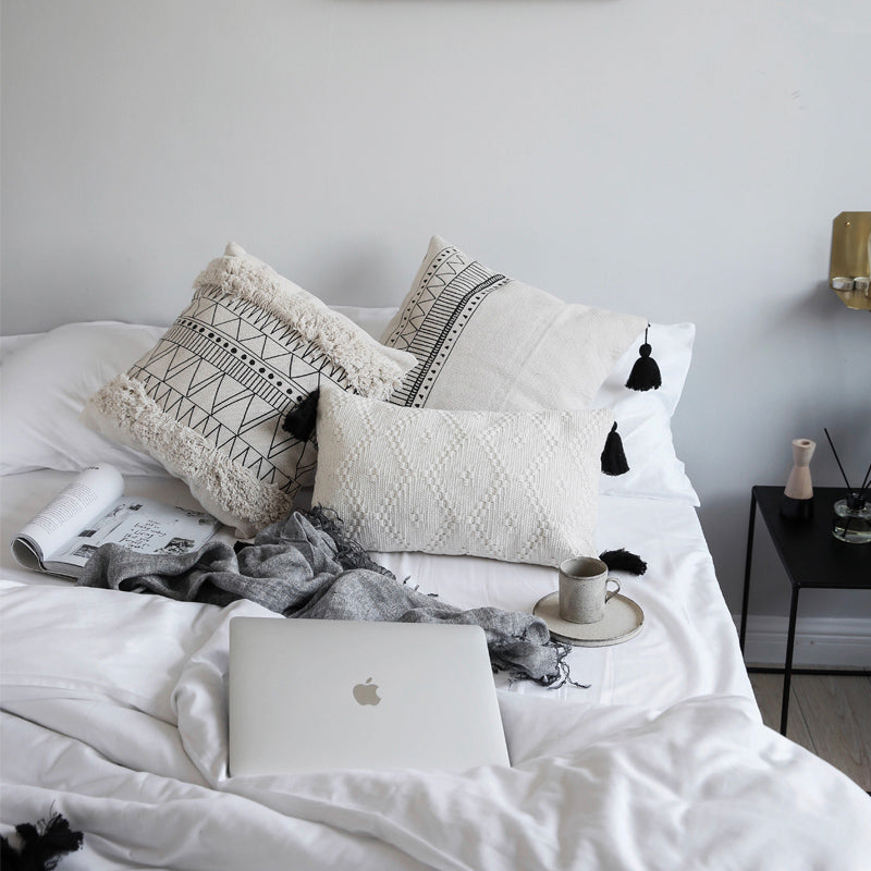 Geometric black and white tufted tassel pillow