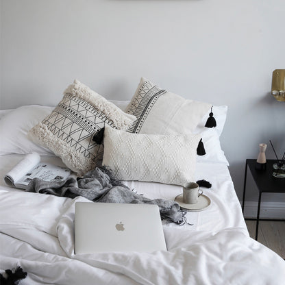Geometric black and white tufted tassel pillow